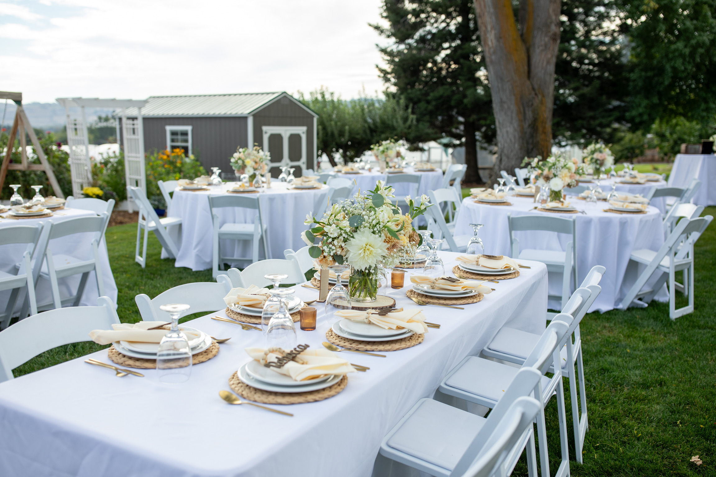 Outdoor event tables arranged on the lawn at Pleasant Hills Farm